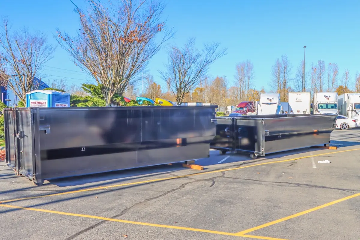 Professional dumpster rental service with roll-off container on residential driveway in Crandall